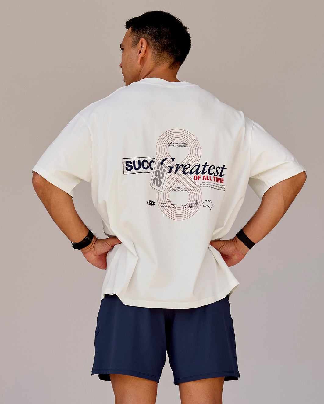 Man wearing Greatest of All Time Heavyweight FLXCotton Oversized Tee - Off White Washed-Scarlet | Model:Shane | Size:L - view 3