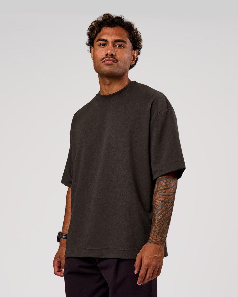 Man wearing AfterDark ZeroCrease Oversized Tee - Onyx | Model:Xav | Size:L