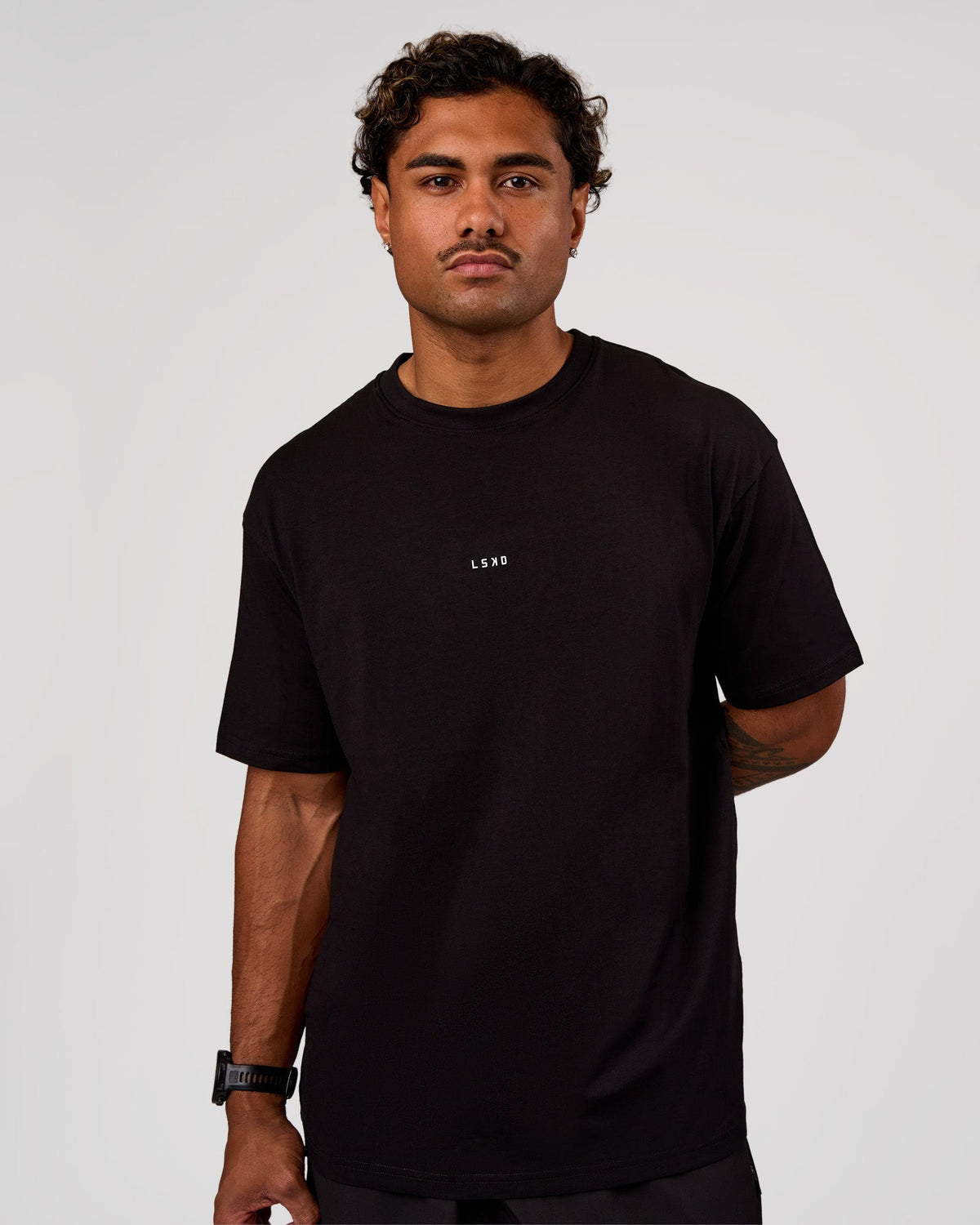 Man wearing Base FLXCotton Tee Oversized - Black | Model:Xav | Size:L