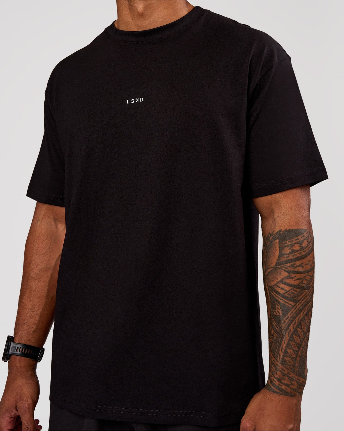 Man wearing Base FLXCotton Tee Oversized - Black | Model:Xav | Size:L