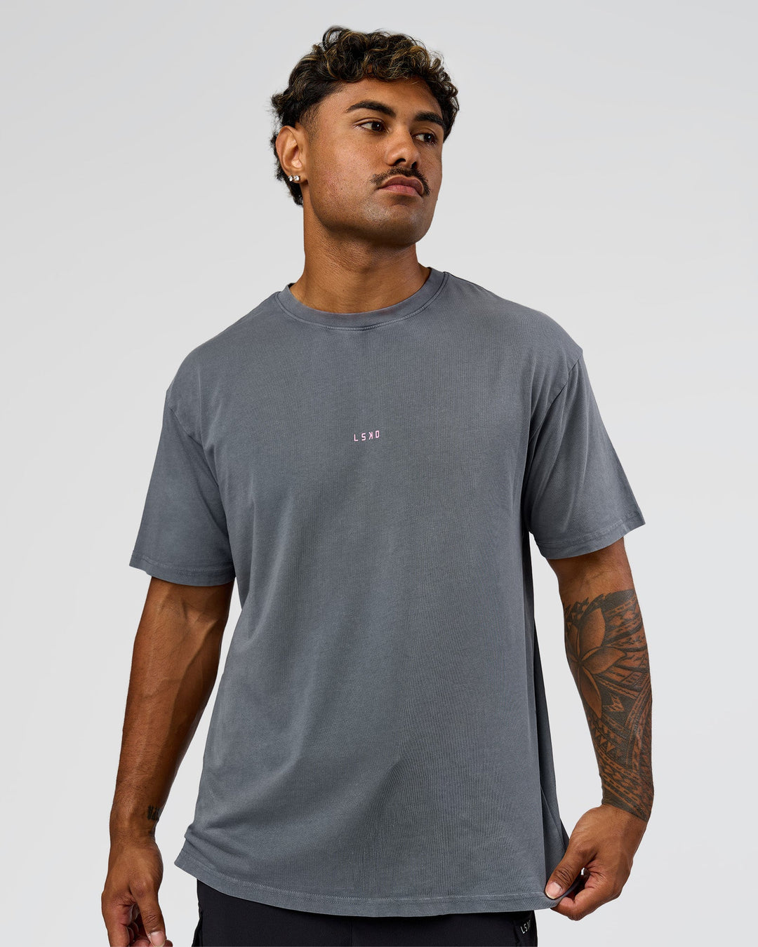 Man wearing Built On Values FLXCotton Oversized Tee - Dark Storm Washed-Pink Rose | Model:Xav | Size:L - view 9