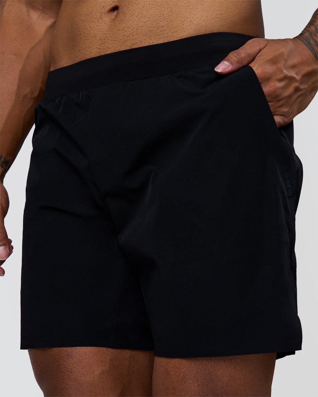 Man wearing Hybrid Lined 7" Short - Black | Model:Xav | Size:L - view 1