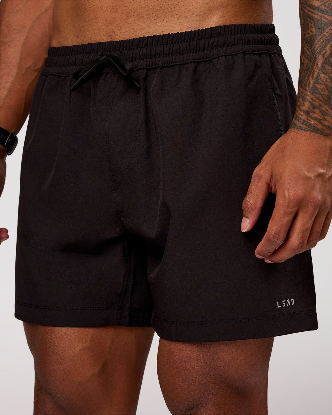 Man wearing Rep 5" Performance Short - Black | Model:Xav | Size:L - view 1