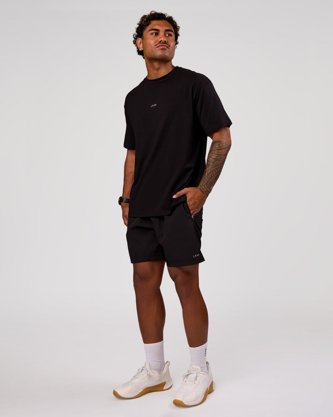 Man wearing Rep 7" Performance Short - Black-White | Model:Xav | Size:L - view 4
