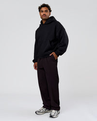 Man wearing Tonal Legacy Boxy Hoodie - Black-Black | Model:Xav | Size:L | Thumbnail Index: 9