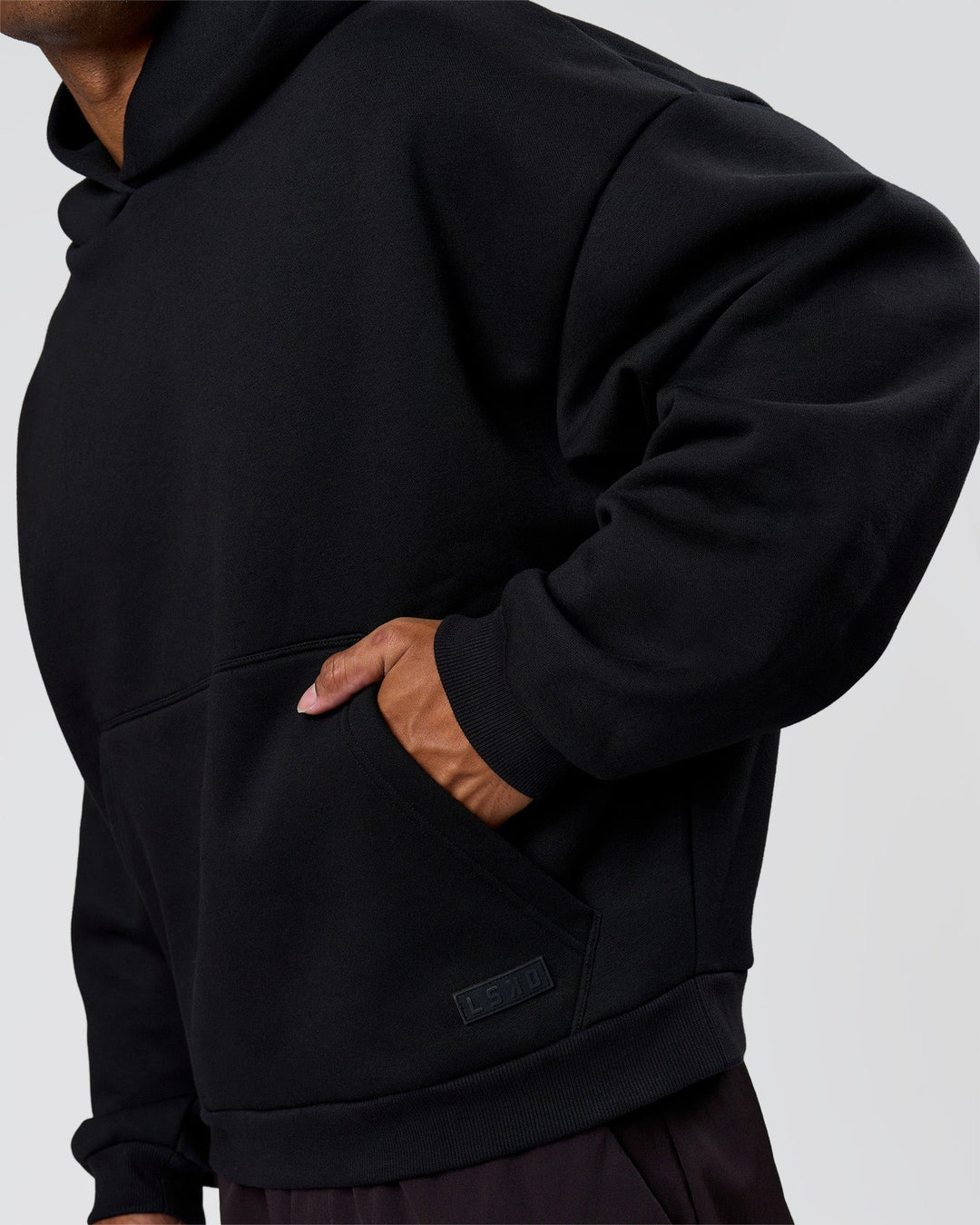 Man wearing Tonal Legacy Boxy Hoodie - Black-Black | Model:Xav | Size:L - view 14