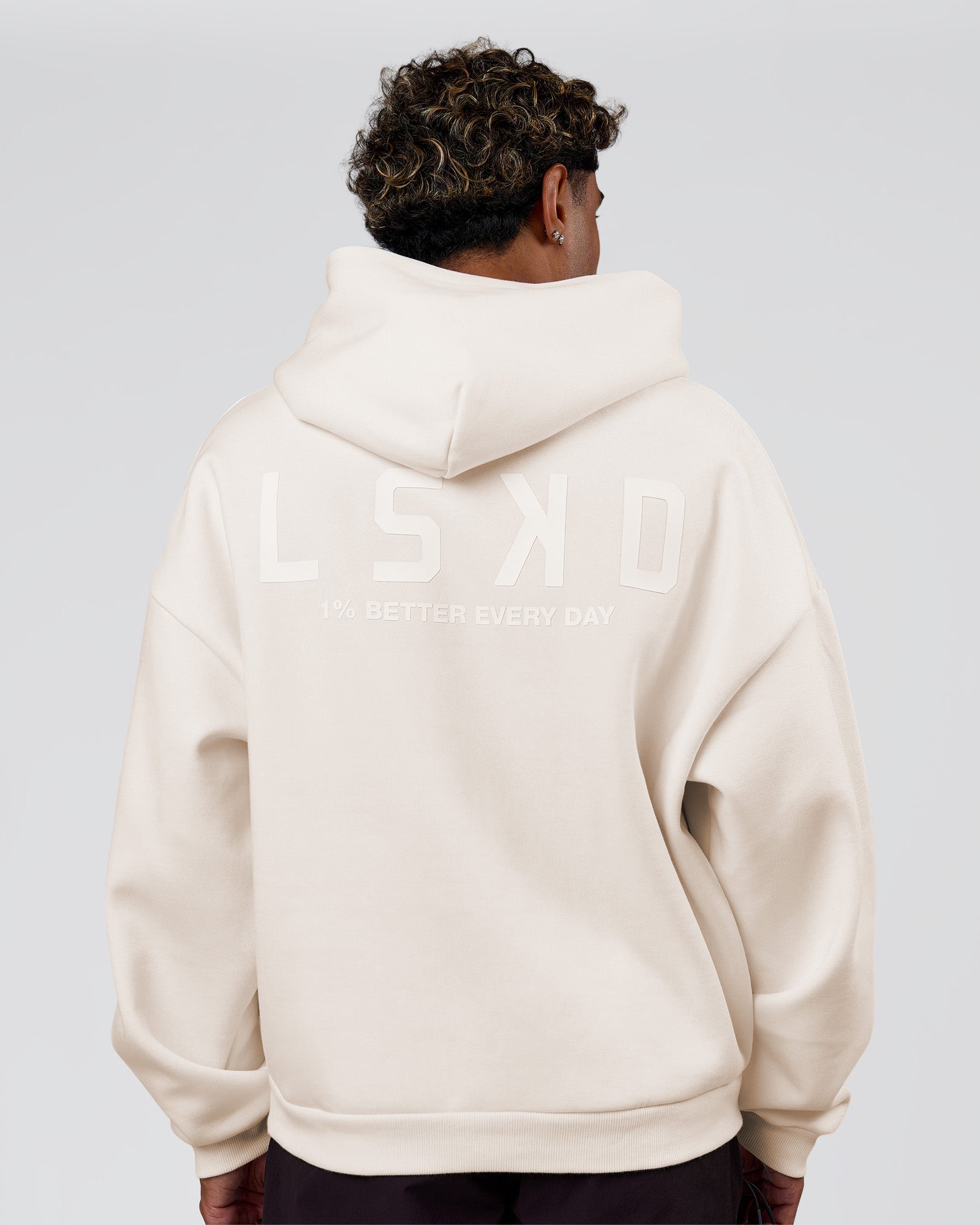 Man wearing Tonal Legacy Boxy Hoodie - Off White-Off White | Model:Xav | Size:L