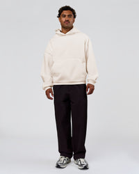 Man wearing Tonal Legacy Boxy Hoodie - Off White-Off White | Model:Xav | Size:L | Thumbnail Index: 7