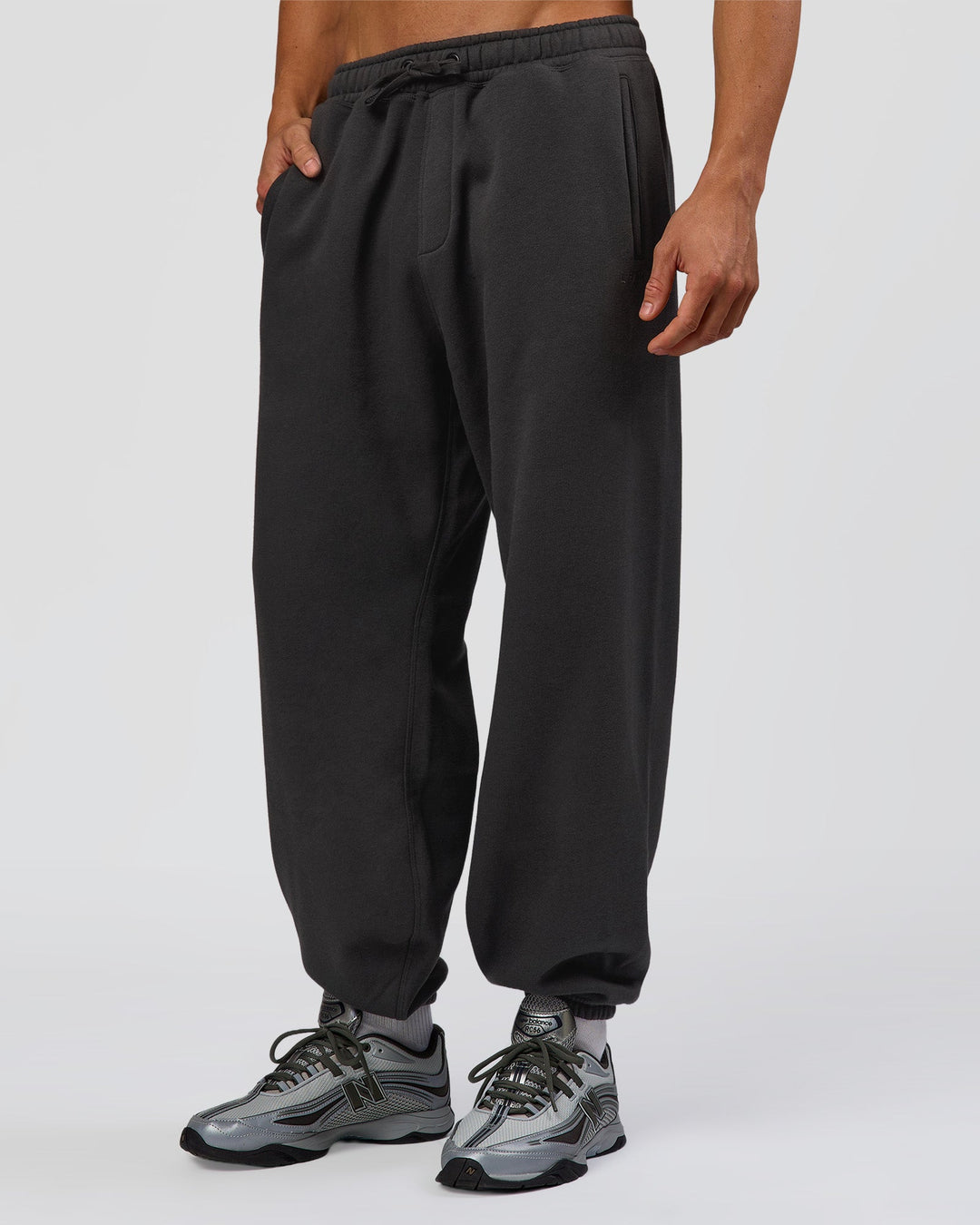 Man wearing Base Baggy Cuffed Track Pant - Onyx | Model:Albert | Size:M - view 1