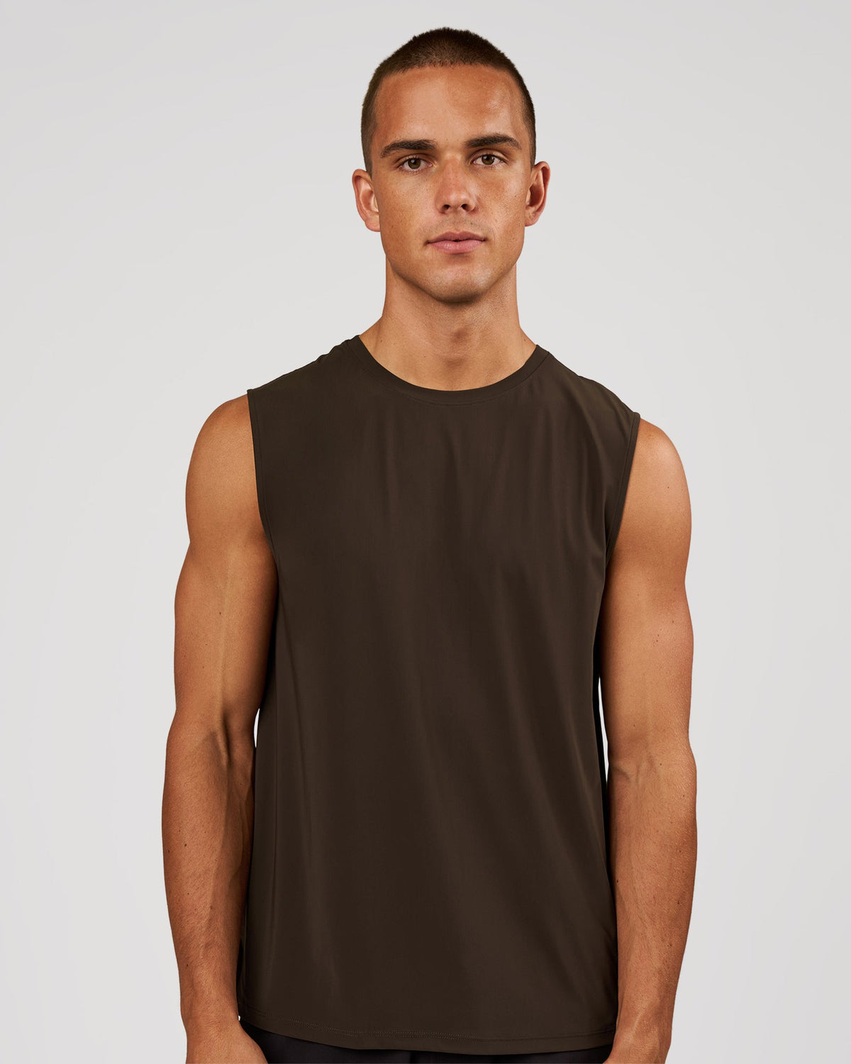 Man wearing Cadence Swift Muscle Tank - Ground Coffee | Model:Albert | Size:M