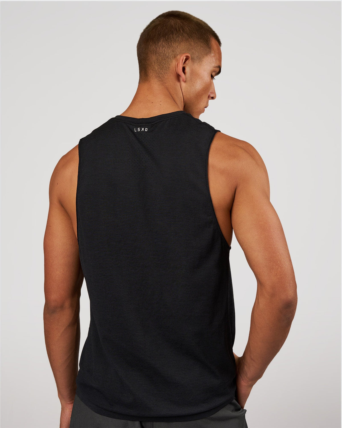 Man wearing AeroFLX+ Seamless Muscle Tank - Black Marl | Model:Albert | Size:M