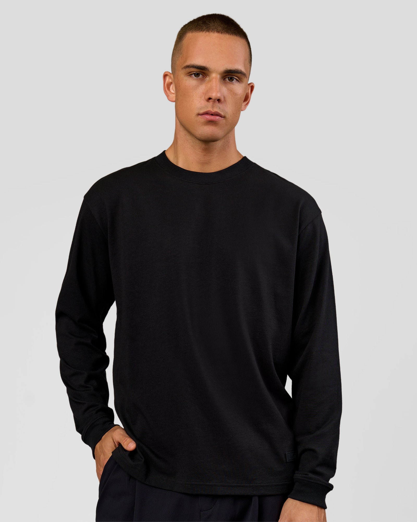 Man wearing Tonal Legacy Heavyweight Oversized LS Tee - Black-Black | Model:Albert | Size:M