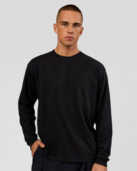 Man wearing Tonal Legacy Heavyweight Oversized LS Tee - Black-Black | Model:Albert | Size:M | Thumbnail Index: 1