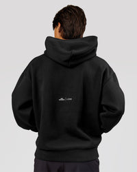 Man wearing Movember x LSKD Oversized Hoodie - Black | Model:George | Size:M | Thumbnail Index: 3