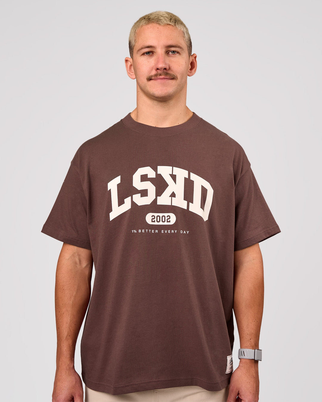 Man wearing Varsity EST Heavyweight Oversized Tee  - Cocoa Powder-Off White | Model:Jaiden | Size:M - view 2