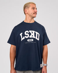 Man wearing Varsity EST Heavyweight Oversized Tee  - Future Navy-White | Model:Jaiden | Size:M | Thumbnail Index: 7