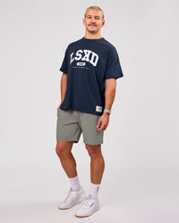 Man wearing Varsity EST Heavyweight Oversized Tee  - Future Navy-White | Model:Jaiden | Size:M | Thumbnail Index: 10