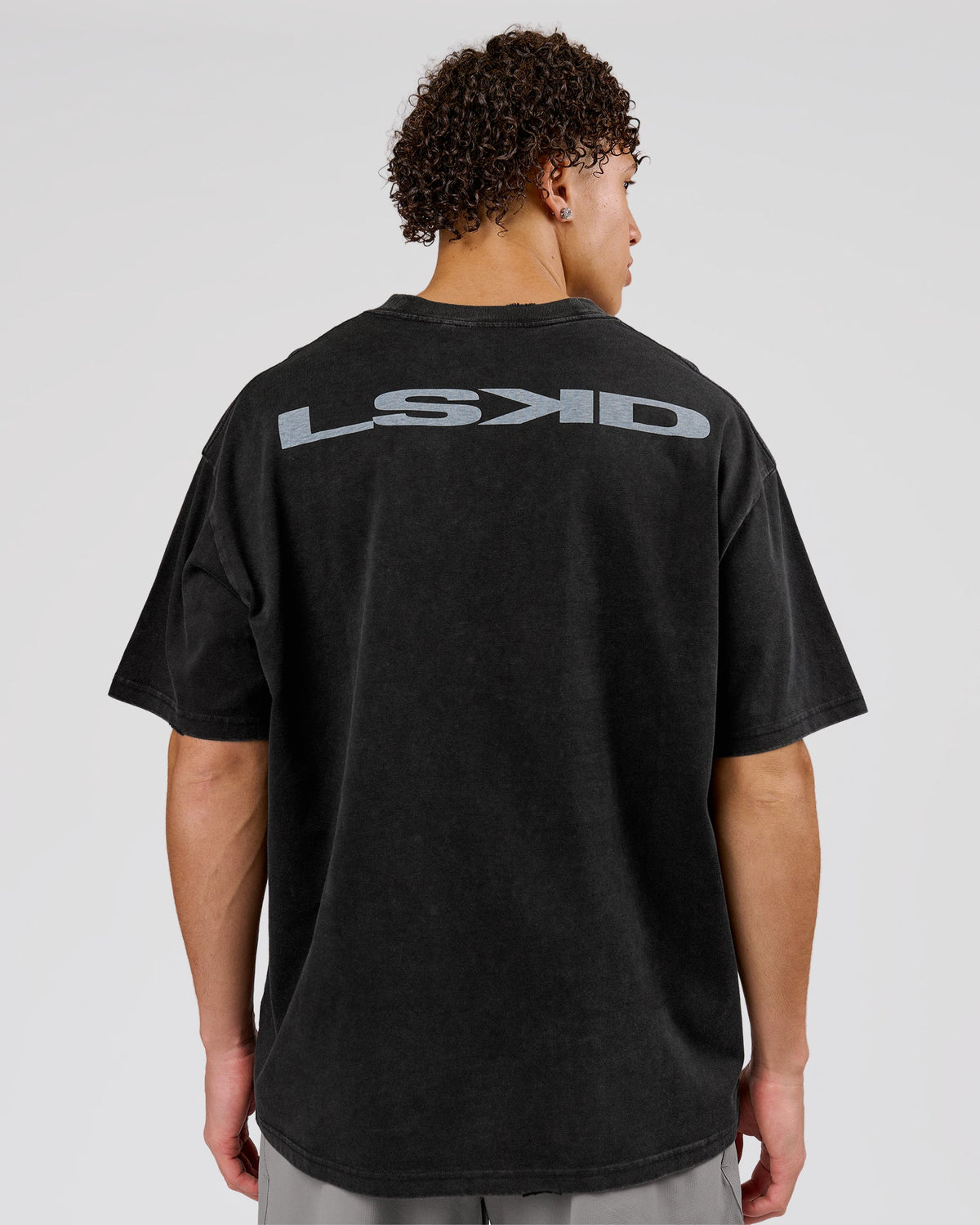 Man wearing Backline Washed Heavyweight Oversized Tee - Black Washed | Model:Leandro | Size:M - view 1