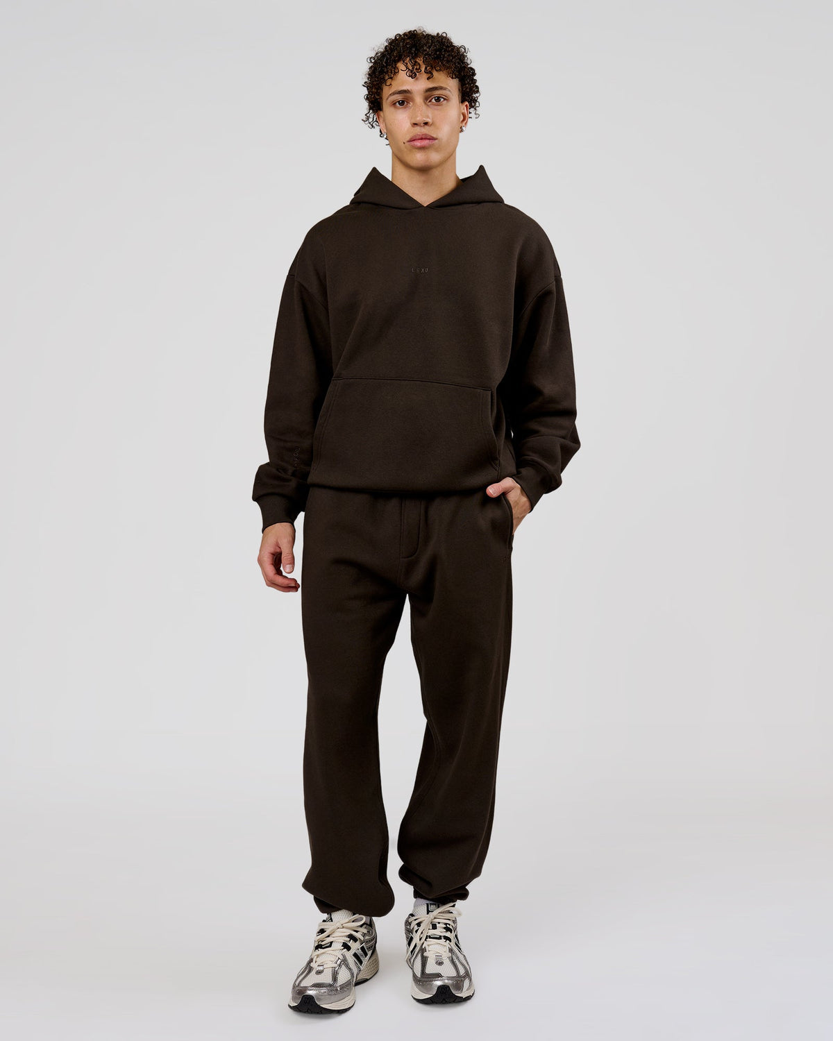 Man wearing Base Baggy Cuffed Track Pant - Ground Coffee | Model:Leandro | Size:M