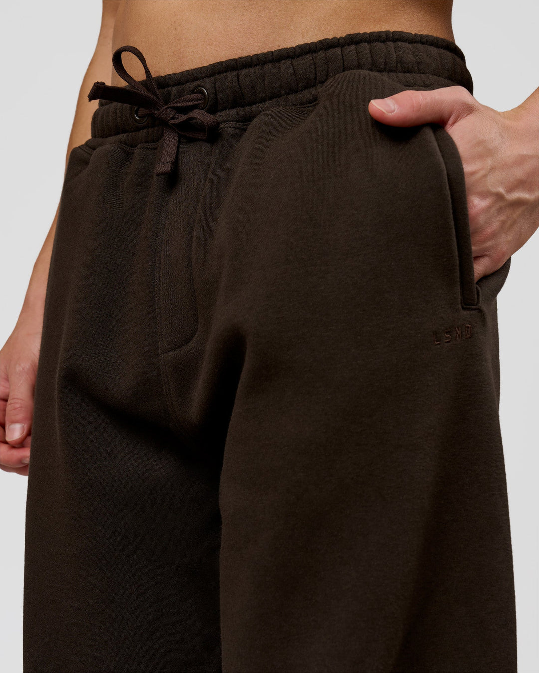 Man wearing Base Baggy Cuffed Track Pant - Ground Coffee | Model:Leandro | Size:M - view 4