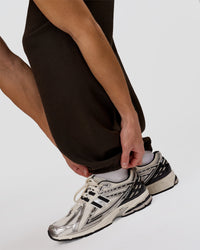 Man wearing Base Baggy Cuffed Track Pant - Ground Coffee | Model:Leandro | Size:M | Thumbnail Index: 7