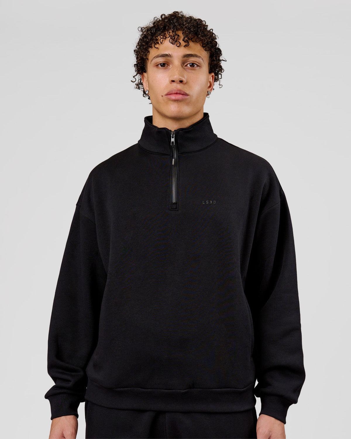 Man wearing Base Quarter Zip Sweater - Black | Model:Leandro | Size:M - view 1