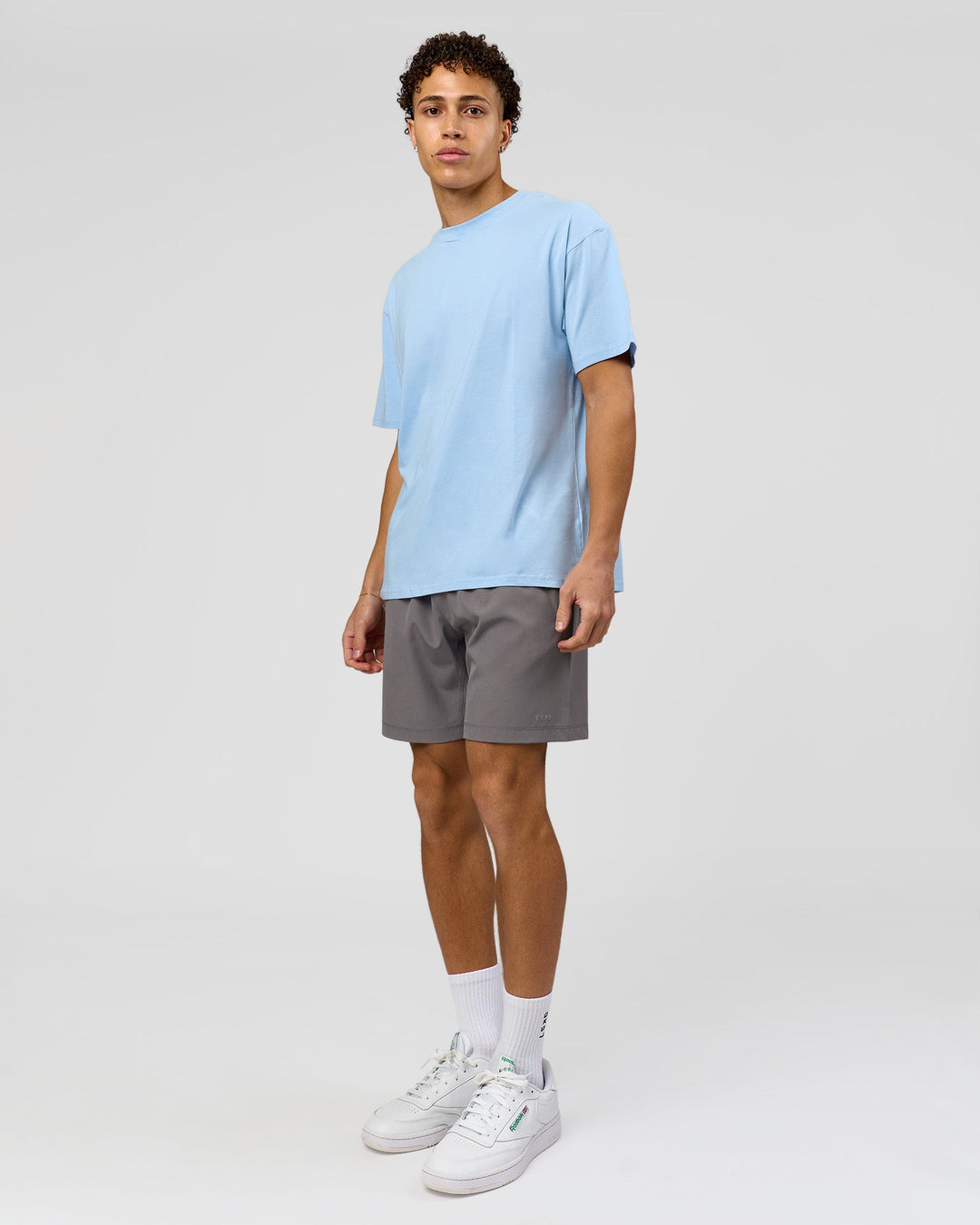 Man wearing Benchmark FLXCotton Oversized Tee - Open Air-Blue Bell | Model:Leandro | Size:M