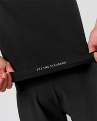 Man wearing Movember x LSKD Drive Seamless Polo - Black | Model:Leandro | Size:M | Thumbnail Index: 2