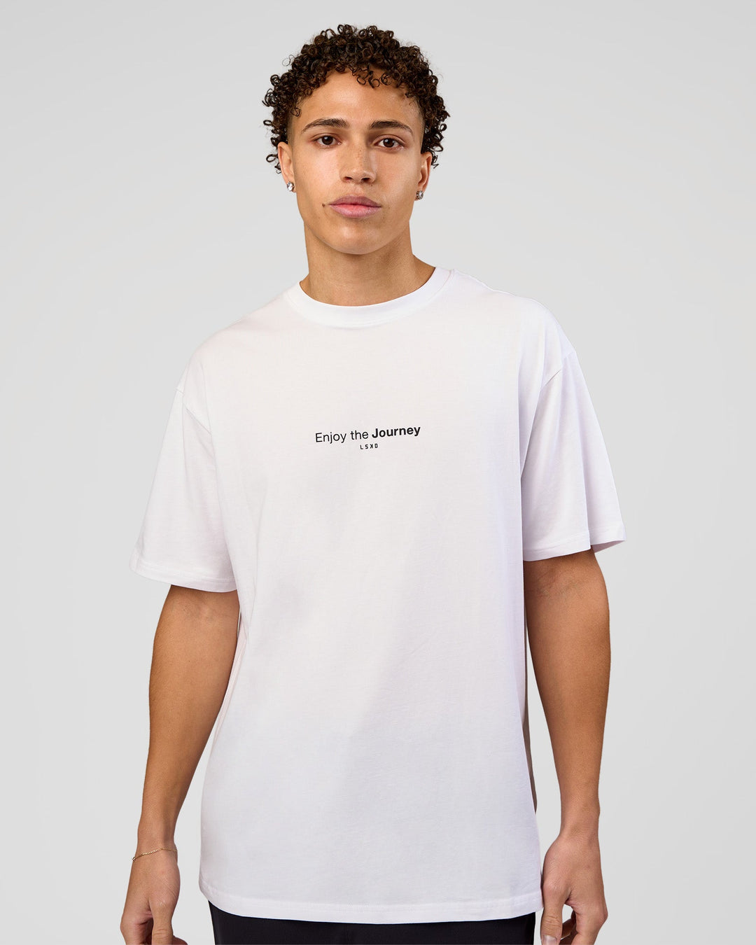 Man wearing VS1 Enjoy The Journey FLXCotton Oversize Tee - White | Model:Leandro | Size:M - view 2