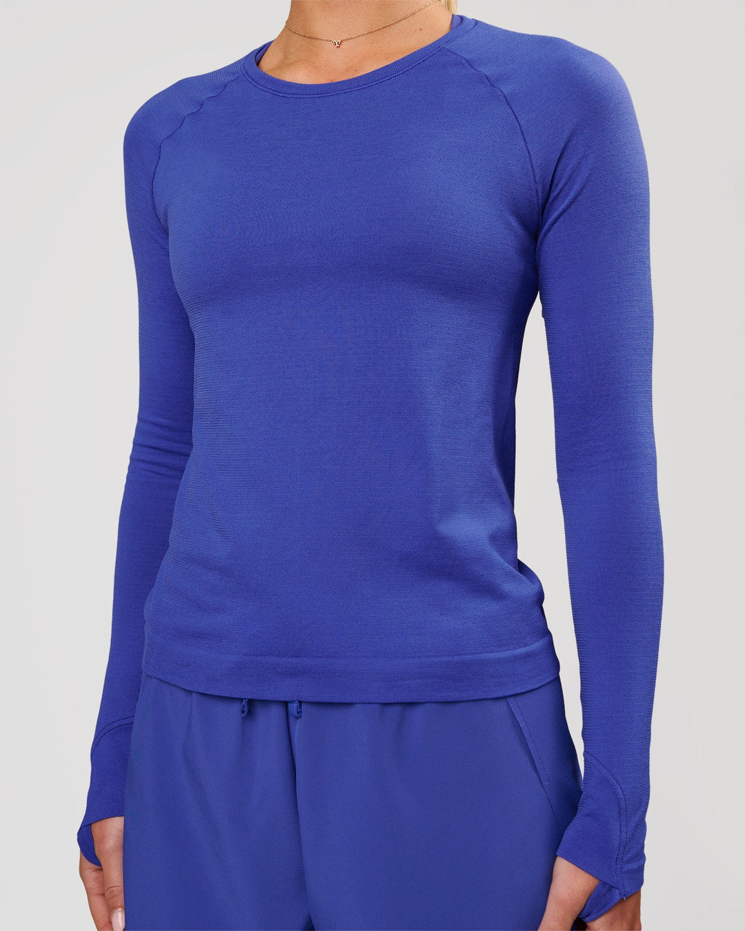 Woman wearing Aeroflx+ Seamless Long Sleeve Tee in Power Cobalt | Model: Issy | Size: XS - view 6