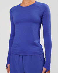 Woman wearing Aeroflx+ Seamless Long Sleeve Tee in Power Cobalt | Model: Issy | Size: XS | Thumbnail Index: 5