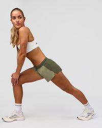 Woman wearing Accelerate 3" Mid-Rise Running Short - Pure Olive-Fog | Model:Xs | Size:ISSY | Thumbnail Index: 3