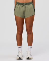 Woman wearing Accelerate 3" Mid-Rise Running Short - Pure Olive-Fog | Model:Xs | Size:ISSY | Thumbnail Index: 4