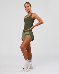 Woman wearing Accelerate 3" Mid-Rise Running Short - Pure Olive-Fog | Model:Xs | Size:ISSY | Thumbnail Index: 7