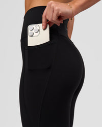Woman wearing Fusion O.G Ultra High-Rise 7/8 Legging Pockets - Black | Model:Issy| Size:XS | Thumbnail Index: 2