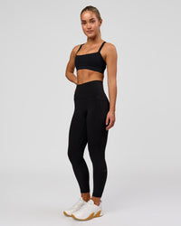 Woman wearing Fusion O.G Ultra High-Rise 7/8 Legging Pockets - Black | Model:Xs | Size:ISSY | Thumbnail Index: 4
