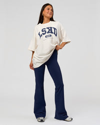 Woman wearing Varsity EST Heavyweight Oversized Tee  - Off White-Future Navy | Model:Bianca | Size:L