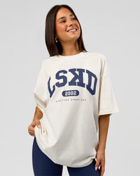 Woman wearing Varsity EST Heavyweight Oversized Tee  - Off White-Future Navy | Model:Bianca | Size:L