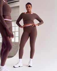 Woman wearing Bree Fusion High-Rise Full Length Legging Pockets - Cocoa Powder-Pink Rose | Model:Cass | Size:L | Thumbnail Index: 2