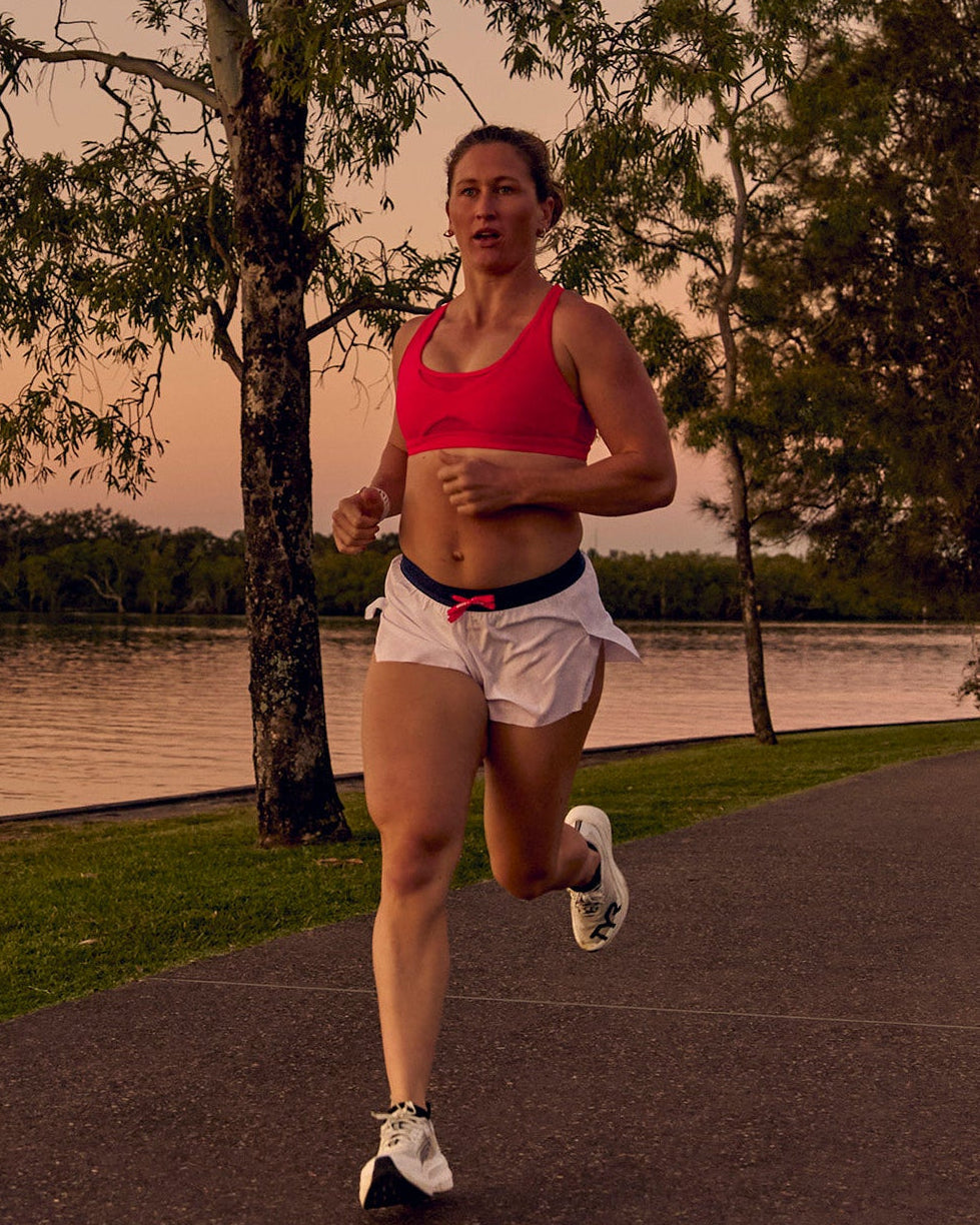 Woman wearing Accelerate 3" Mid-Rise Running Short - White-Future Navy | Model:Tia | Size:M - view 1
