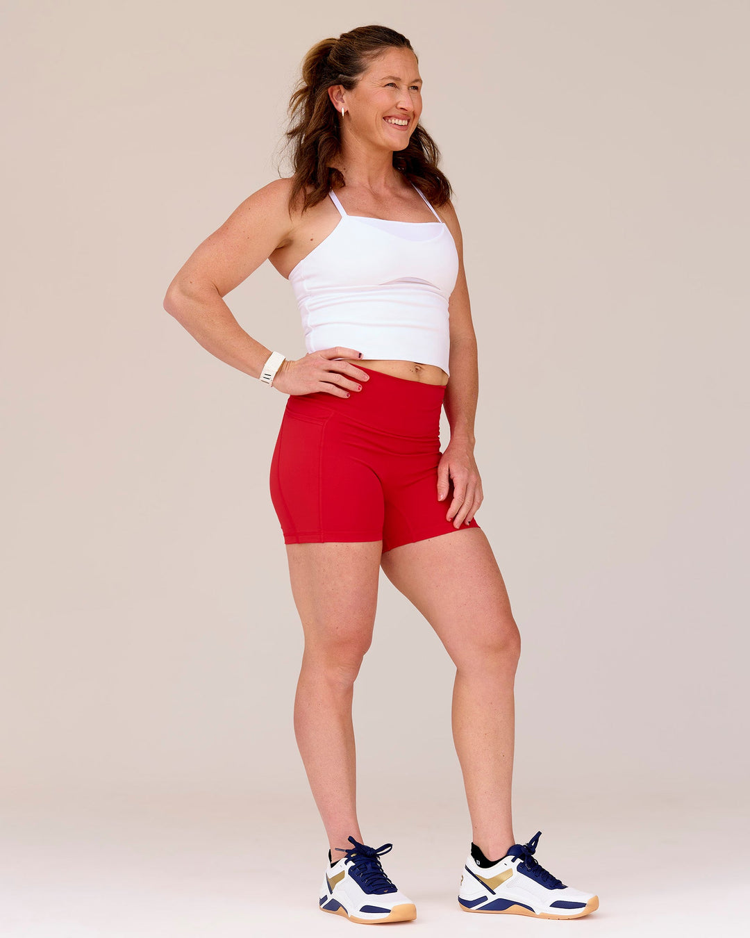 Woman wearing Fusion Ultra High-Rise 6" Short Pockets - Scarlet | Model:Tia | Size:M - view 1