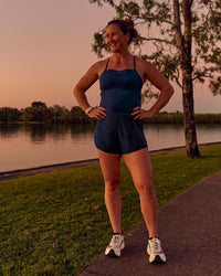 Woman wearing Tia-Clair Toomey-Orr Legacy 3" Run One-Piece - Future Navy | Model:Tia | Size:M | Thumbnail Index: 1