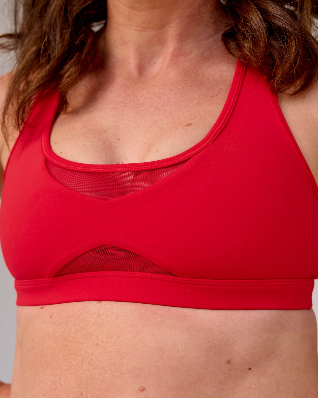 Woman wearing Unstoppable Racerback Sports Bra - Scarlet | Model:Tia | Size:M - view 4