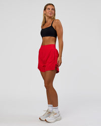 Woman wearing Challenger 5" Lined Performance Short - Scarlet | Model:Amity | Size:S