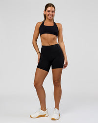 Woman wearing O.G. Fusion High-Rise 6" Short Pockets - Black | Model:Amity | Size:S | Thumbnail Index: 1