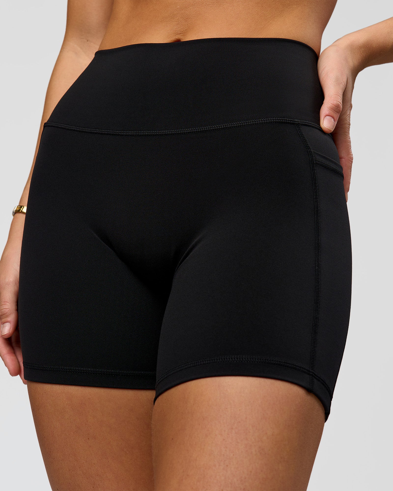 Woman wearing O.G. Fusion High-Rise 6" Short Pockets - Black | Model:Amity | Size:S