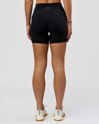 Woman wearing O.G. Fusion High-Rise 6" Short Pockets - Black | Model:Amity | Size:S | Thumbnail Index: 9