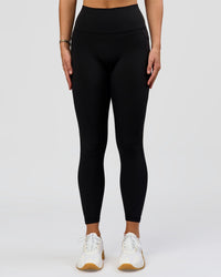 Woman wearing O.G. Fusion High-Rise Full Length Legging Pockets - Black | Model:Amity | Size:S | Thumbnail Index: 1