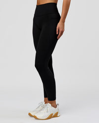 Woman wearing O.G. Fusion High-Rise Full Length Legging Pockets - Black | Model:Amity | Size:S | Thumbnail Index: 6
