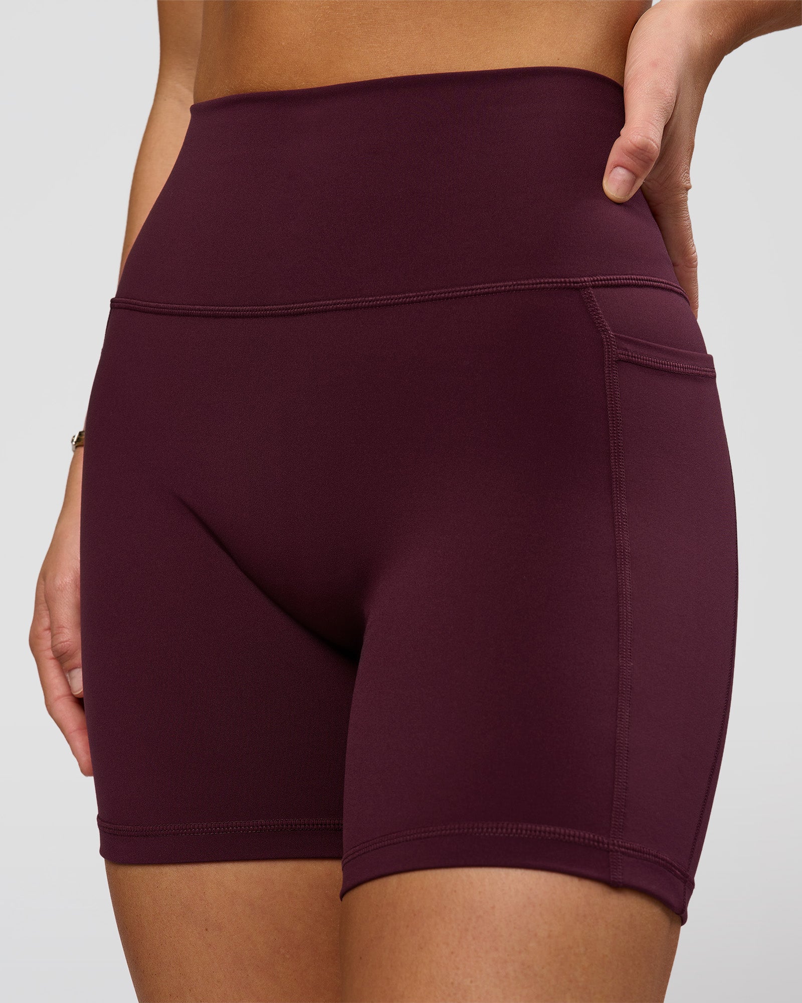 Woman wearing O.G. Fusion Ultra High-Rise 6" Short Pockets - Cherry Lacquer | Model:Amity | Size:S